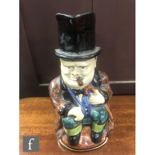 75 - A C.H Brannam character jug modelled as Winston Churchill sat holding a walking cane and smoking a c... 