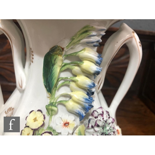 172 - A 19th Century Davenport pedestal ewer decorated with encrusted flowers with a griffin handle, parti... 