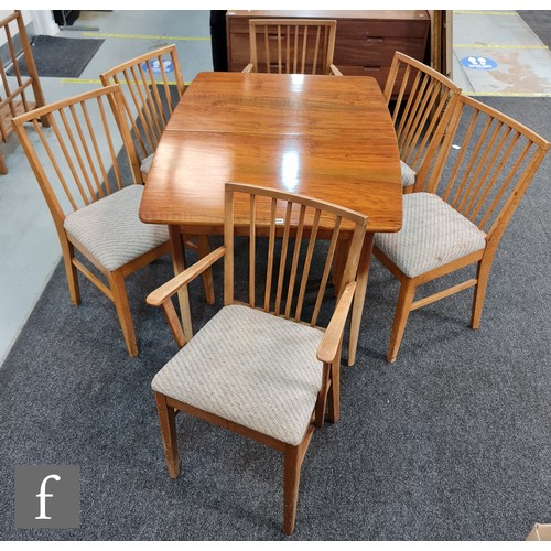 948 - A post war walnut extending dining table of rectangular form, on tapered legs, with an insert leaf, ... 