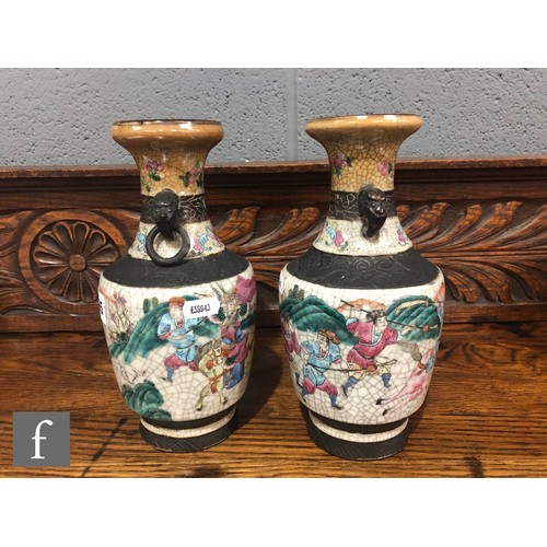 195 - A pair of 20th century Chinese crackle ware vases painted with warriors and figures in landscape sce... 