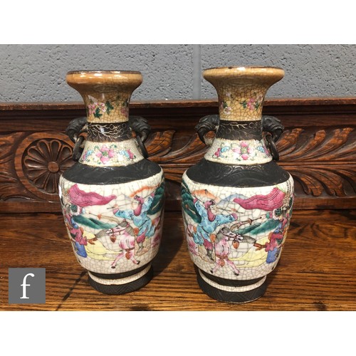 195 - A pair of 20th century Chinese crackle ware vases painted with warriors and figures in landscape sce... 