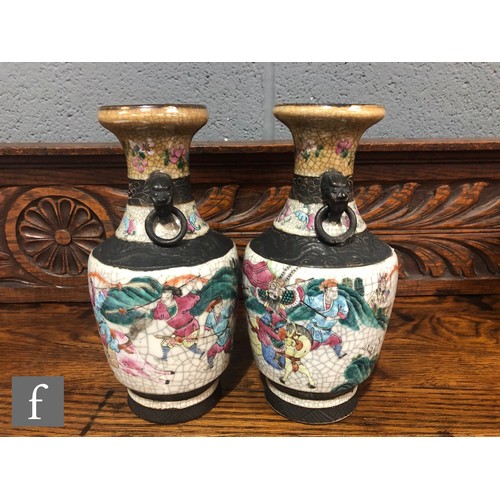 195 - A pair of 20th century Chinese crackle ware vases painted with warriors and figures in landscape sce... 