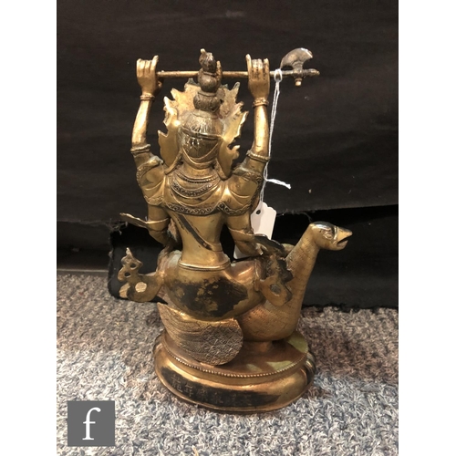 206 - A Sino-Tibetan figure of Avalokitesvara, cast seated on bird, holding a ritual axe aloft, and furthe... 