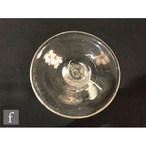 231 - An 18th Century drinking glass, circa 1750, the drawn trumpet bowl above a single series air twist s... 