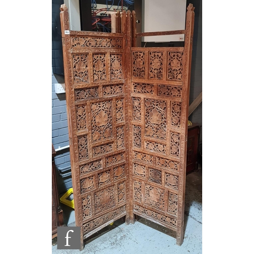 952 - A late 20th Century four fold Asian hardwood dressing screen with pierced foliate panels within a pl... 