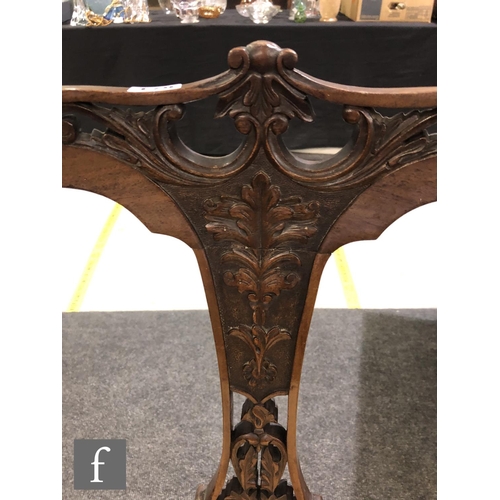 179 - A pair of Edwardian walnut salon chairs having a central pierced and foliate carved splat with acant... 