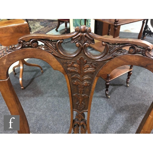 179 - A pair of Edwardian walnut salon chairs having a central pierced and foliate carved splat with acant... 