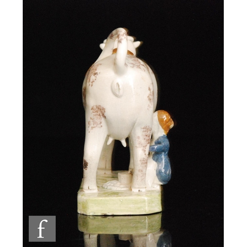 102 - A late 18th to early 19th Century Staffordshire creamware cow creamer and cover with milk maid and p... 