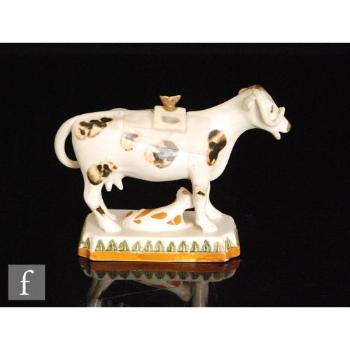 103 - A late 19th to early 20th Century Staffordshire Prattware cow creamer and cover with recumbent calf ... 