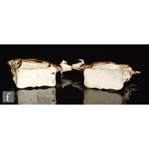 106 - A pair of late 18th to early 19th Century Staffordshire creamware cow creamers and covers, both stoo... 