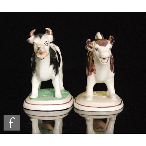 110 - Two 19th Century Staffordshire cow creamers and covers, the first with dark Sunderland lustre type d... 