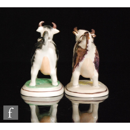 110 - Two 19th Century Staffordshire cow creamers and covers, the first with dark Sunderland lustre type d... 