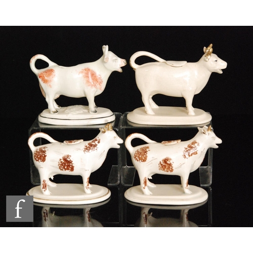 112 - Four assorted 19th Century Staffordshire cow creamers and covers comprising two with brown sponged d... 