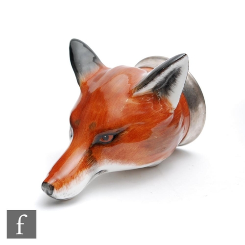 52 - A later 20th Century Bloor China stirrup cup formed as the head of a fox with a silver coloured meta... 