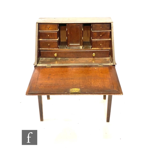 599 - A George III oak writing desk, fitted with a drawer interior enclosed by a plain fall over a single ... 