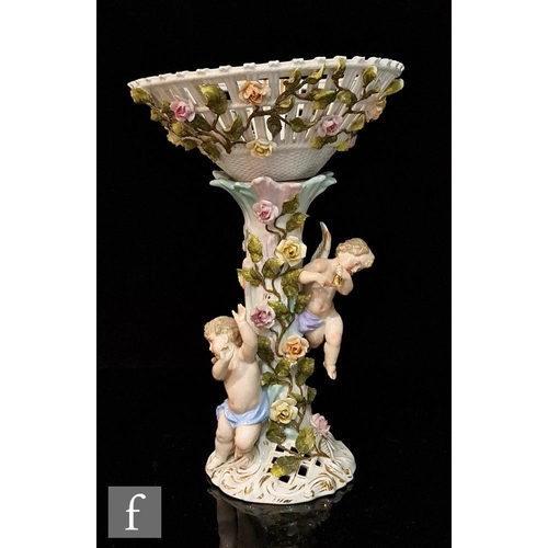 76 - A 20th Century Dresden type table centre comport, the pedestal with two frolicking winged cherubs am... 