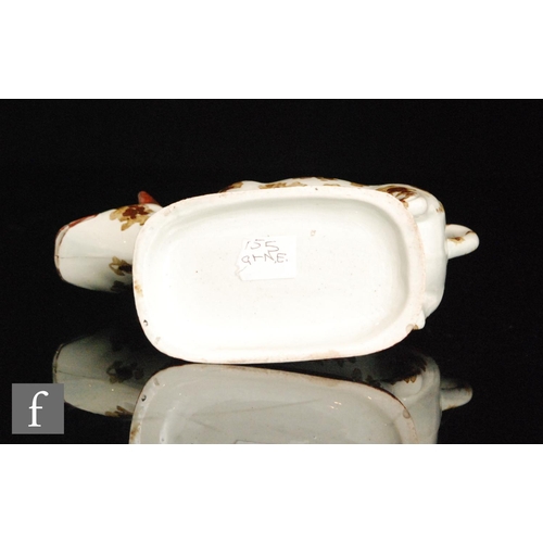 91 - An early 19th Century cow creamer and cover, possibly Welsh, decorated with two tone brown patches w... 