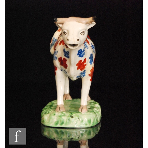 94 - A 19th Century Welsh cow creamer, possibly Cambrian, with burnt red and blue spotted decoration stoo... 