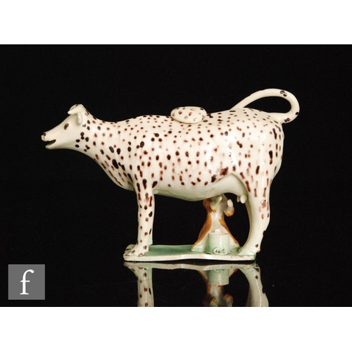 97 - A late 18th to early 20th Century Staffordshire creamware cow creamer and cover with milk maid and p... 