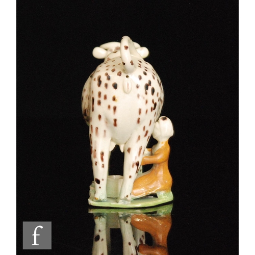 97 - A late 18th to early 20th Century Staffordshire creamware cow creamer and cover with milk maid and p... 