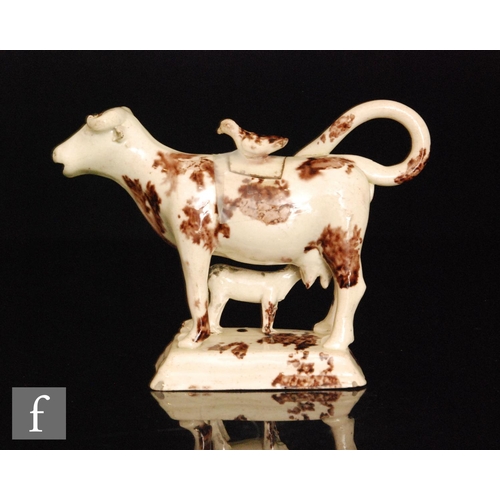 99 - A late 18th to early 19th Century Staffordshire cow creamer and cover with calf beneath, cow with Wh... 