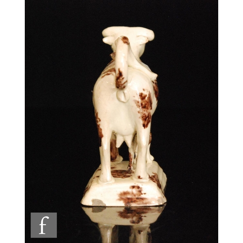 99 - A late 18th to early 19th Century Staffordshire cow creamer and cover with calf beneath, cow with Wh... 