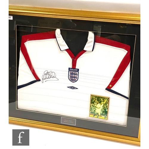 1692 - A framed England home shirt 2003/4 signed by Michael Owen, with insert action photograph, 72cm x 89c... 