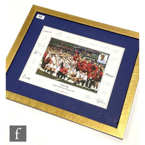 1696 - A facsimile signed photograph of the England World Cup Rugby winners 2003 team in celebration 45.5cm... 