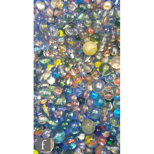 317 - A large collection of glass marbles, mostly swirl examples, most with pontil marks and bubbles, of v... 