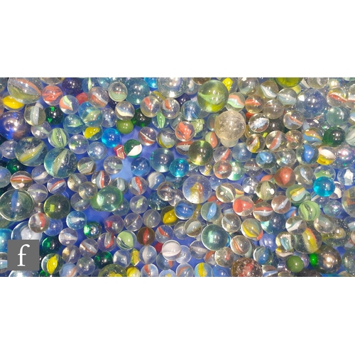 317 - A large collection of glass marbles, mostly swirl examples, most with pontil marks and bubbles, of v... 