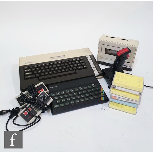 1115 - A collection of vintage gaming items, to include an Atari 800XL computer, with power supply, Atari 1... 