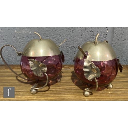 168 - A pair of late 19th Century cranberry glass preserve pots of fluted ovoid form mounted to EPNS frame... 