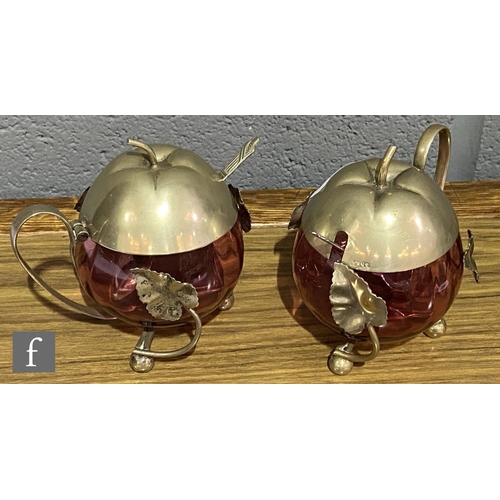 168 - A pair of late 19th Century cranberry glass preserve pots of fluted ovoid form mounted to EPNS frame... 