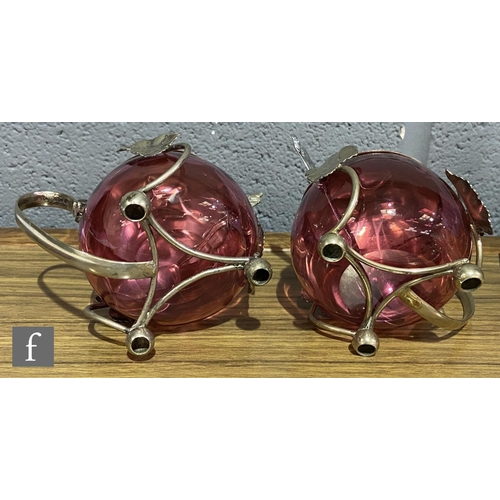 168 - A pair of late 19th Century cranberry glass preserve pots of fluted ovoid form mounted to EPNS frame... 