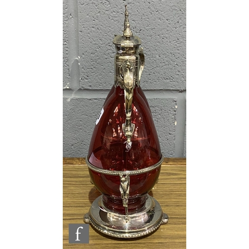 216 - A 19th Century claret jug set comprising two ruby glass claret jugs of footed ovoid form with applie... 