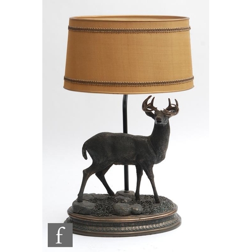 1854 - A stag table lamp, the stepped oval base surmounted by a stag in standing position, with all over br... 