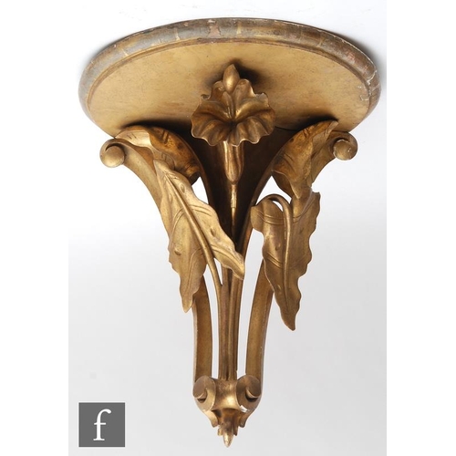 1855 - A giltwood wall bracket, the semi-circular upper plinth supported by a carved lily pediment, termina... 