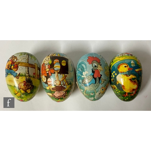 1147 - Four German card Easter eggs with lacquered decoration of rabbits and chickens, largest 11.5cm.