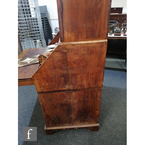 625 - An early 18th Century crossbanded and feather banded walnut bureau bookcase, the shelf and drawer in... 