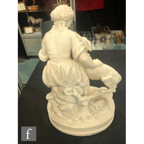 80 - A 19th Century Parian figure of a lady sat offering her dog a biscuit, unmarked, height 35cm.