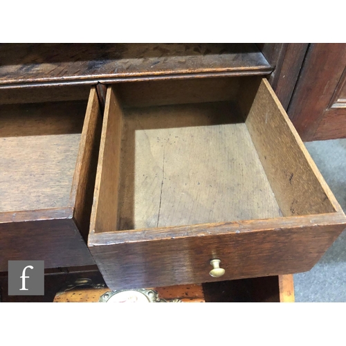 625 - An early 18th Century crossbanded and feather banded walnut bureau bookcase, the shelf and drawer in... 