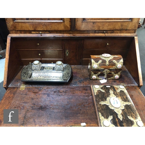 625 - An early 18th Century crossbanded and feather banded walnut bureau bookcase, the shelf and drawer in... 