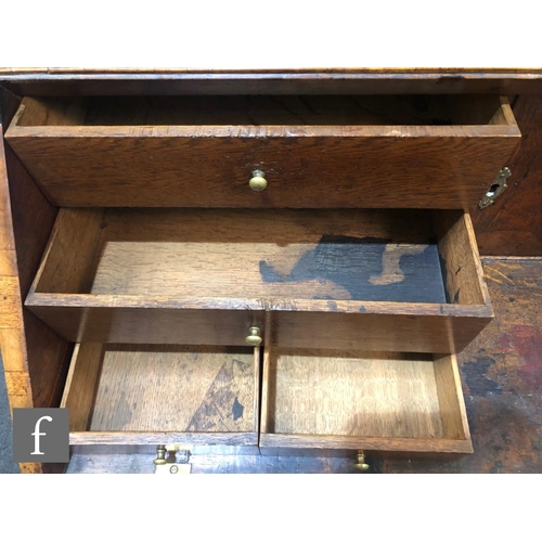 625 - An early 18th Century crossbanded and feather banded walnut bureau bookcase, the shelf and drawer in... 