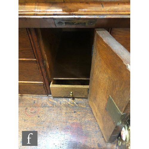 625 - An early 18th Century crossbanded and feather banded walnut bureau bookcase, the shelf and drawer in... 