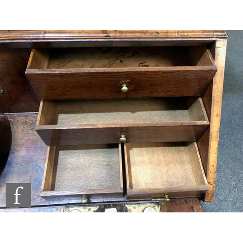 625 - An early 18th Century crossbanded and feather banded walnut bureau bookcase, the shelf and drawer in... 