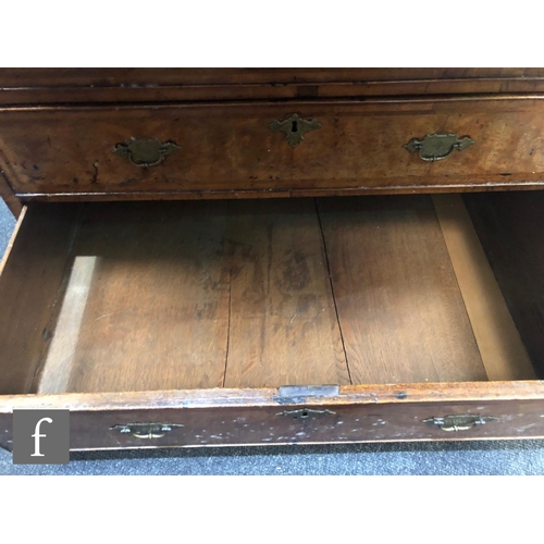 625 - An early 18th Century crossbanded and feather banded walnut bureau bookcase, the shelf and drawer in... 