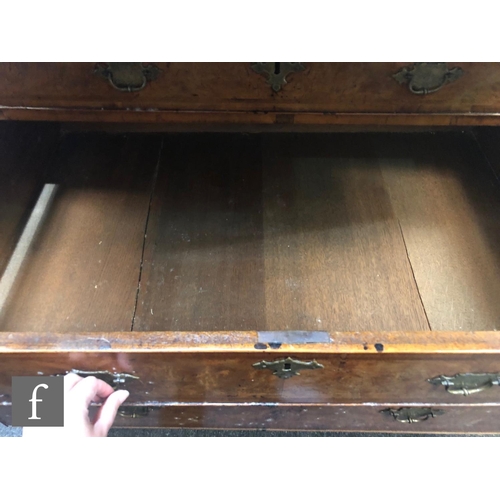 625 - An early 18th Century crossbanded and feather banded walnut bureau bookcase, the shelf and drawer in... 