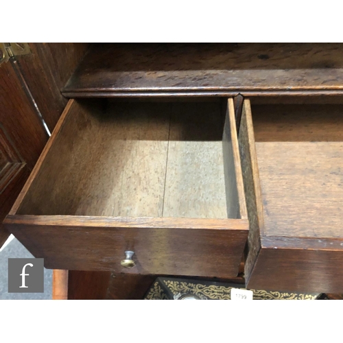 625 - An early 18th Century crossbanded and feather banded walnut bureau bookcase, the shelf and drawer in... 