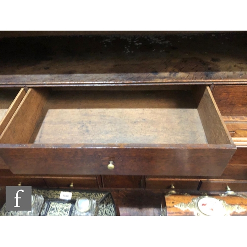 625 - An early 18th Century crossbanded and feather banded walnut bureau bookcase, the shelf and drawer in... 