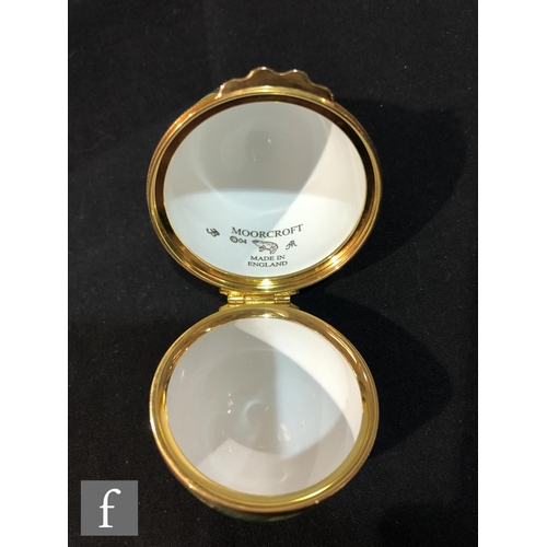 72 - A Moorcroft Enamels egg shaped trinket box and cover decorated with hand painted daffodil and pussy ... 